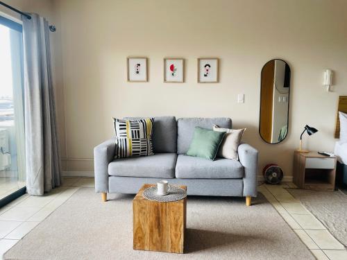a living room with a couch and a table at Studio in the City in Cape Town