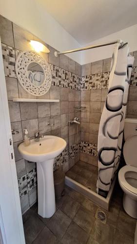 a bathroom with a sink and a toilet at Armonia Guesthouse in Panormos Skopelos