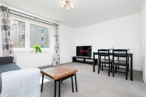 a living room with a couch and a table at 2 Bedroom Flat - Free Parking- by Holiday Homes in Clydebank