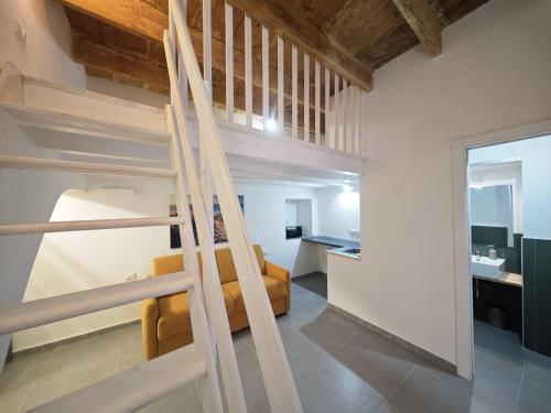 a room with a loft bed and a bathroom at Monolocale Zena in Carloforte