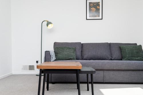 a living room with a couch and a table at 2 Bedroom Flat - Free Parking- by Holiday Homes in Clydebank
