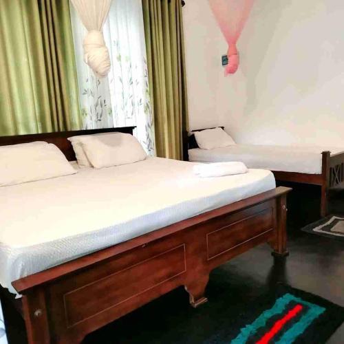 a bedroom with a bed and a tub at Dambulla Sun Vsh Holiday in Dambulla