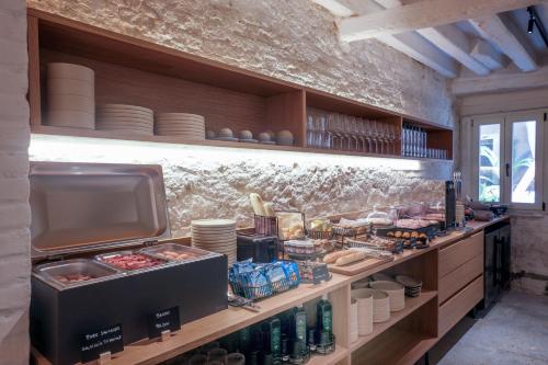 a kitchen with a counter with food and drinks at Hotel Casa W in Venice