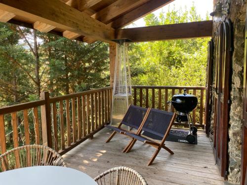 a porch with a hammock and a grill at Casa Rural Pirineu Nevà in Nevà