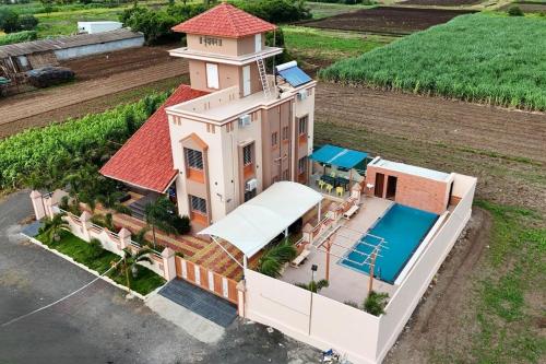 an aerial view of a house with a swimming pool at Lux Pvt Pool, Rain Dance, Near Bhimashankar, Pets! in Manchar