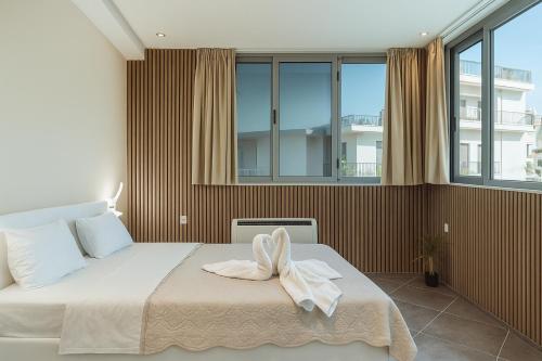 a bedroom with a bed with a towel on it at Parthenon Portrait Apartments in Athens