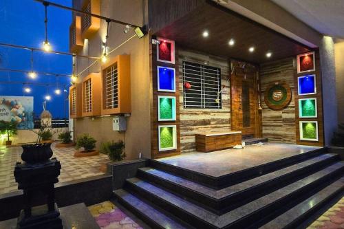 a staircase in a building with colorful windows at Lux Pvt Pool, Rain Dance, Near Bhimashankar, Pets! in Manchar