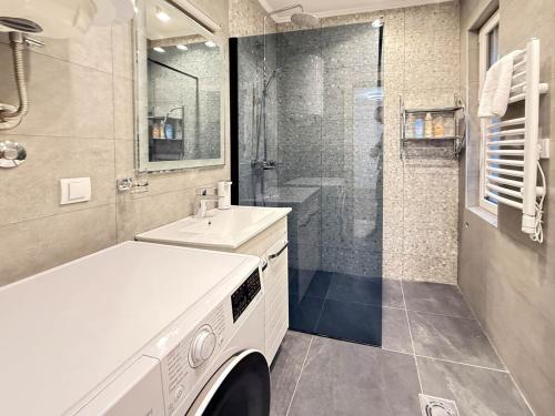 a white bathroom with a sink and a shower at Skadarlija Soul in Želenička Stanica Beograd Sava