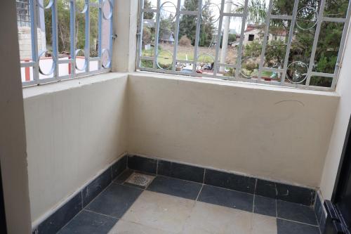 a corner of a room with a window at Axis Guest House in Syokimau