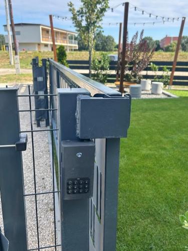 a fence with a pay meter in a park at Cappello Vendégház in Baja