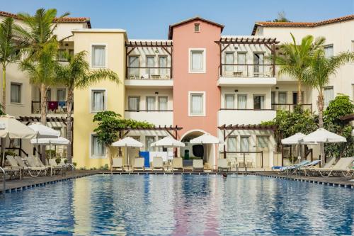 a swimming pool in front of buildings at Louis Althea Beach in Protaras