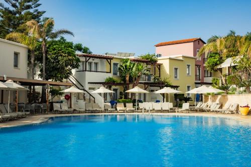 a large swimming pool with chairs and umbrellas at Louis Althea Beach in Protaras