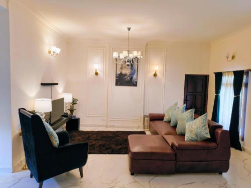 a living room with a couch and a chair at Villa Forever Coorg in Madikeri