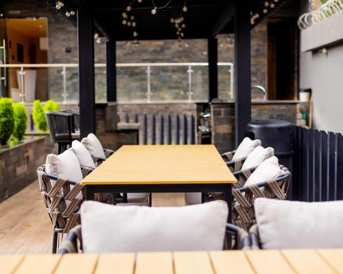 a wooden table and chairs in a restaurant at Pretty haven-studio apartment -Kilimani in Nairobi