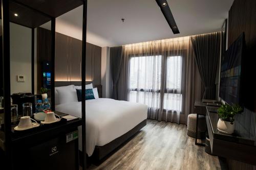 a hotel room with a bed and a large window at GrandView Hotel & Residence Hanoi in Hanoi
