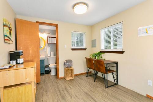 a room with a desk and a bathroom with a toilet at Breakwater Resort in Grayland