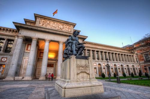 a statue in front of a large building at La Casita de Christian in Madrid