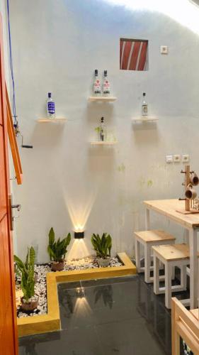 a room with a fish pond and tables and shelves at Homestay Pantai Pangandaran in Pangandaran