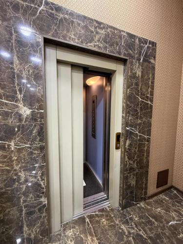 a bathroom mirror with a reflection of a hallway at Pilot By Haz Hotel in Baku