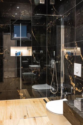 a bathroom with two sinks and a toilet and a shower at Villa del Sol Mostar in Mostar
