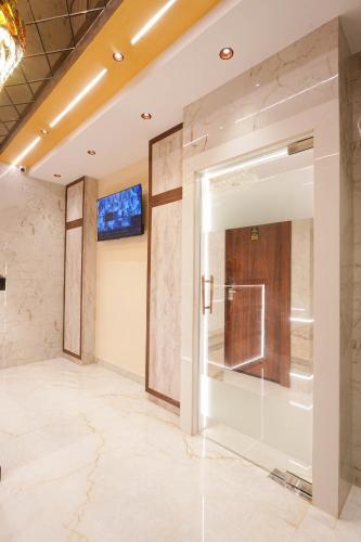 an elevator lobby with a sliding glass door at Hotel Prince Palace in Mumbai