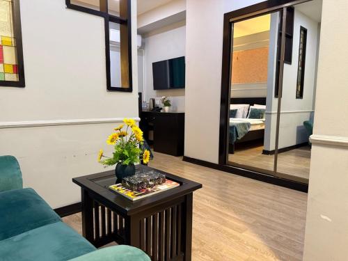 a living room with a couch and a mirror at Pilot By Haz Hotel in Baku