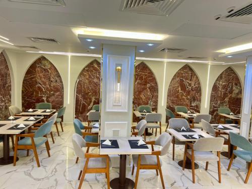 a dining room with tables and chairs and stone walls at Salma Hotel Cairo in Cairo
