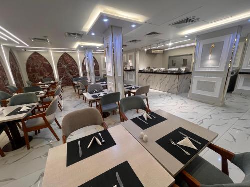 a restaurant with tables and chairs and a counter at Salma Hotel Cairo in Cairo