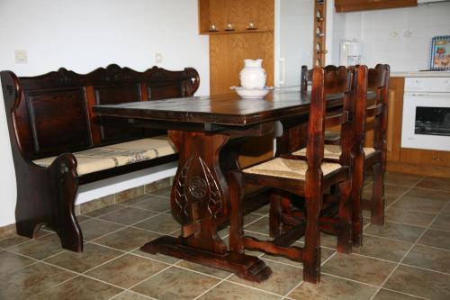 a wooden dining room table with chairs and a couch at Villa Carina in Kounopetra