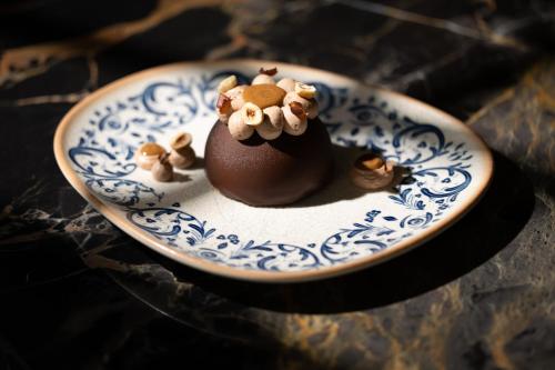 a small chocolate dessert on a blue and white plate at Idou Malabata Beach and SPA in Tangier