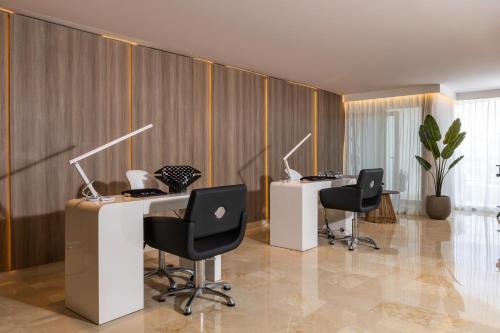 an office with three desks with computers on them at Idou Malabata Beach and SPA in Tangier
