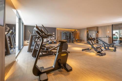 a gym with treadmills and ellipticals in a room at Idou Malabata Beach and SPA in Tangier