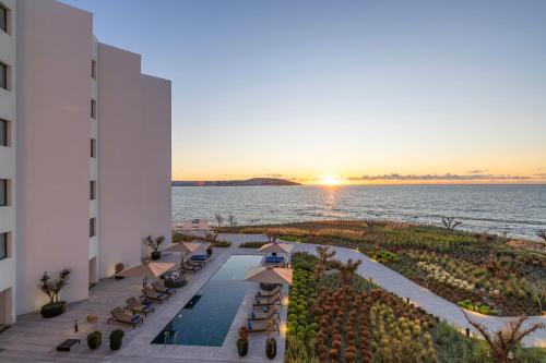 an aerial view of a hotel and the ocean at sunset at Idou Malabata Beach and SPA in Tangier
