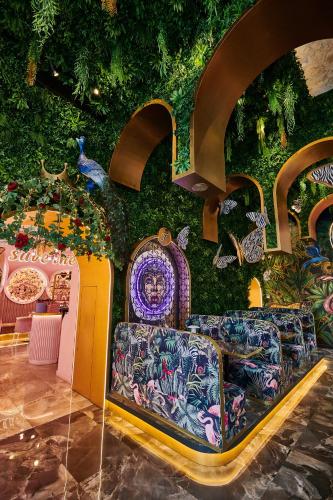 a room with a wall covered in plants at Fairytale Athens Suites in Athens