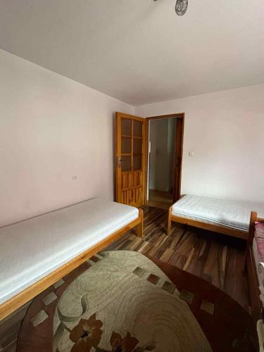 a room with two beds in a room at Agroturystyka Beskid Niski Dukla TERESA in Dukla