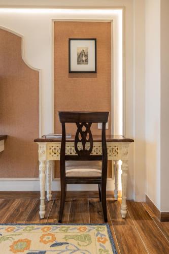 a chair sitting at a table in a room at The Residency - A Boutique Hotel in Jodhpur