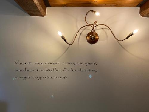 a light hanging on a wall with a sign on it at Agriturismo Tenuta Badia in Paciano