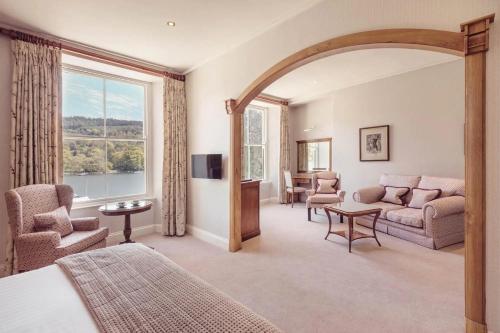 a bedroom with a bed and a living room at Lakeside Hotel and Spa in Newby Bridge