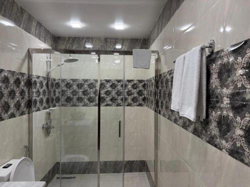 a bathroom with a shower and a toilet and a sink at Pilot By Haz Hotel in Baku