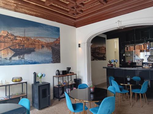 a dining room with blue chairs and a table at Monsenhor52 in Porto