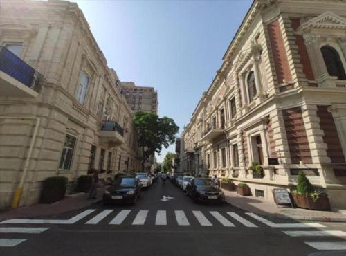 a city street with cars parked on the street at Pilot By Haz Hotel in Baku