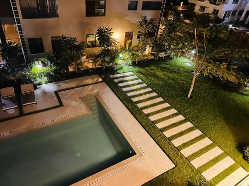 a backyard with a swimming pool in a building at Diani Beachfront Villa Amani at Diani in Ukunda