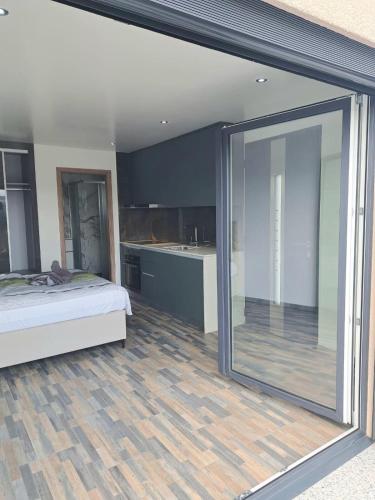 ein Schlafzimmer mit einem Bett und einem großen Glasfenster in der Unterkunft Panoramic studio in Surpierre