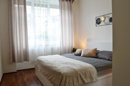 a bedroom with a bed in front of a window at Apartmán u Fontány in Poděbrady