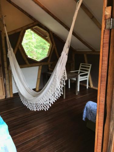 a hammock in a room with a window at Refugio Cumaná Entero in San Rafael