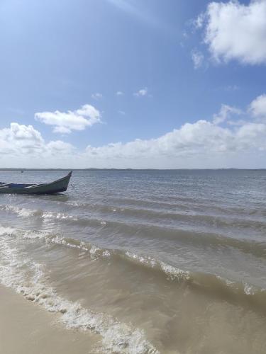a boat in the water on the beach at Charmoso Village no Povoado de Coqueiros in Jandaíra