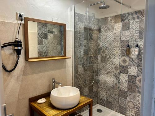a bathroom with a sink and a shower at Hotel Mas Des Barres in Saintes-Maries-de-la-Mer