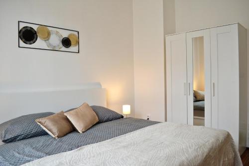 a bedroom with a bed and a picture on the wall at Apartmán u Fontány in Poděbrady