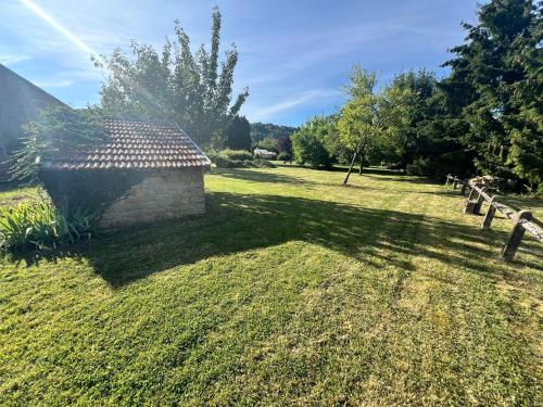 a building in the middle of a grass field at Le Gîte d'antan - L'Artdu'Net - in Omicourt