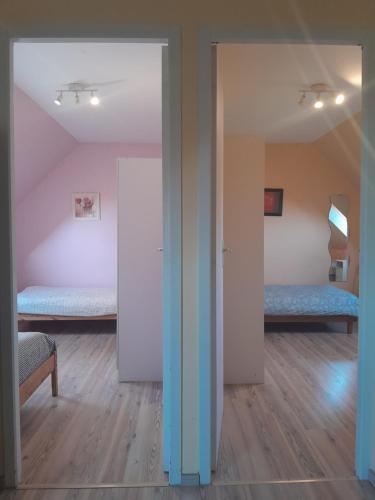 a room with two beds and a room with a hallway at Appartement 4 couchages Le nid de l'écureuil in Donges